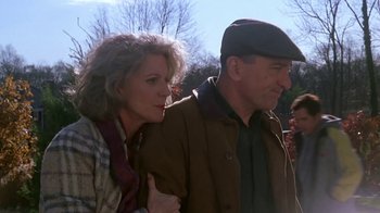 Movie still from “Meet the Parents” (2000), directed by Jay Roach – A man and a woman standing next to each other; Medium shot, Low angle