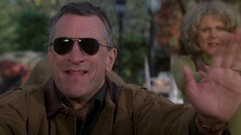 Movie still from “Meet the Parents” (2000), directed by Jay Roach – A person wearing a jacket and sunglasses; Close Up shot, Low angle