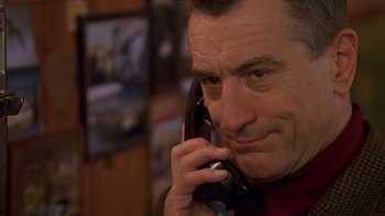 Movie still from “Meet the Parents” (2000), directed by Jay Roach – A person talking on a cell phone; Close Up shot, Low angle