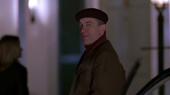 Movie still from “Meet the Parents” (2000), directed by Jay Roach – A man wearing a hat and a brown jacket; Close Up shot, Over the shoulder angle