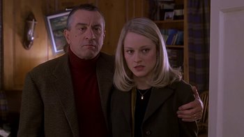 Movie still from “Meet the Parents” (2000), directed by Jay Roach – A man and a woman pose for a picture; Close Up shot, Low angle