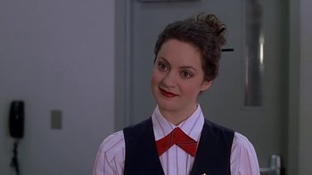 Movie still from “Meet the Parents” (2000), directed by Jay Roach – A woman in a red bow tie and a white shirt; Close Up shot, Over the shoulder angle