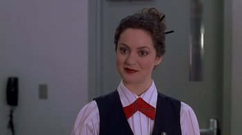 Movie still from “Meet the Parents” (2000), directed by Jay Roach – A woman in a red bow tie standing in front of a door; Close Up shot, High angle