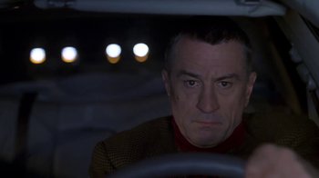 Movie still from “Meet the Parents” (2000), directed by Jay Roach – A man sitting in the drivers seat of a car at night; Close Up shot, Over the shoulder angle