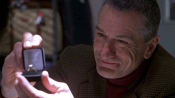 Movie still from “Meet the Parents” (2000), directed by Jay Roach – A person taking a picture with a cell phone; Close Up shot, Over the shoulder angle