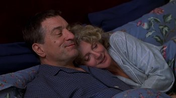 Movie still from “Meet the Parents” (2000), directed by Jay Roach – A man and a woman laying in bed together; Medium shot, Low angle