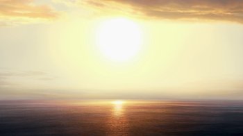 Movie still from “Megamind” (2010), directed by Tom McGrath – The sun is setting over the ocean with the sky in the background; Extreme Wide shot, High angle