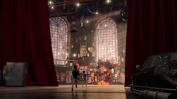 Movie still from “Megamind” (2010), directed by Tom McGrath – A man and a child standing in front of a stage; Extreme Wide shot, Low angle