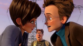 Movie still from “Megamind” (2010), directed by Tom McGrath – A couple of people standing next to each other in front of another person; Close Up shot, Over the shoulder angle