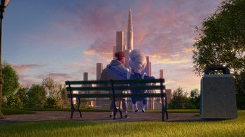 Movie still from “Megamind” (2010), directed by Tom McGrath – Two people sitting on a park bench in front of a city skyline; Extreme Wide shot, Low angle