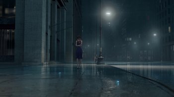 Movie still from “Megamind” (2010), directed by Tom McGrath – A woman standing in the middle of the street at night; Extreme Wide shot, High angle