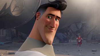 Movie still from “Megamind” (2010), directed by Tom McGrath – A man with black hair is smiling for the camera; Close Up shot, Over the shoulder angle