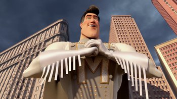 Movie still from “Megamind” (2010), directed by Tom McGrath – A large statue of a man in a suit and hat; Medium shot, Low angle