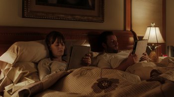 Movie still from “Men, Women & Children” (2014), directed by Jason Reitman – A man and a woman laying in a bed; Medium shot, High angle