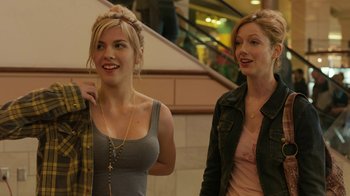 Movie still from “Men, Women & Children” (2014), directed by Jason Reitman – Two young women standing next to each other in front of a staircase; Medium shot, Over the shoulder angle