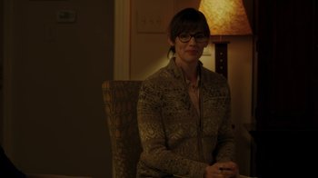 Movie still from “Men, Women & Children” (2014), directed by Jason Reitman – A woman sitting in a chair in front of a lamp; Medium shot, Over the shoulder angle