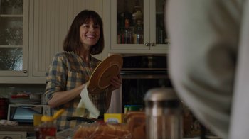 Movie still from “Men, Women & Children” (2014), directed by Jason Reitman – A woman holding a plate in a kitchen; Medium shot, Over the shoulder angle