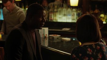 Movie still from “Men, Women & Children” (2014), directed by Jason Reitman – A man in a suit talking to a woman in front of a bar; Medium shot, Over the shoulder angle