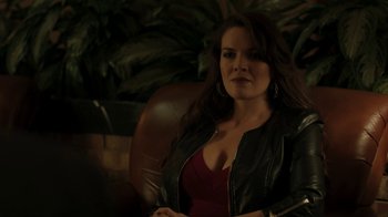 Movie still from “Men, Women & Children” (2014), directed by Jason Reitman – A woman sitting in a chair wearing a leather jacket; Medium shot, Over the shoulder angle