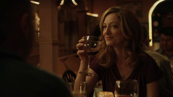 Movie still from “Men, Women & Children” (2014), directed by Jason Reitman – A woman sitting at a table holding a glass of wine; Close Up shot, Over the shoulder angle