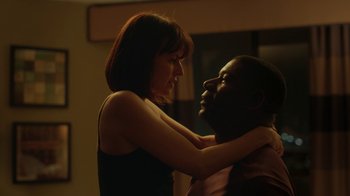 Movie still from “Men, Women & Children” (2014), directed by Jason Reitman – A man and a woman embracing each other in the dark; Medium shot, Low angle