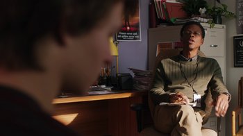 Movie still from “Men, Women & Children” (2014), directed by Jason Reitman – A man sitting in a chair in front of a desk; Medium shot, Over the shoulder angle