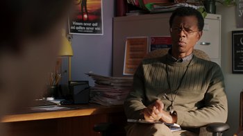 Movie still from “Men, Women & Children” (2014), directed by Jason Reitman – A man sitting at a desk in front of a lamp; Close Up shot, Over the shoulder angle