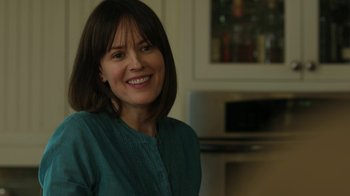 Movie still from “Men, Women & Children” (2014), directed by Jason Reitman – A woman smiling for the camera in a kitchen; Close Up shot, Over the shoulder angle