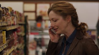 Movie still from “Men, Women & Children” (2014), directed by Jason Reitman – A woman talking on a cell phone while wearing a brown jacket; Close Up shot, Over the shoulder angle