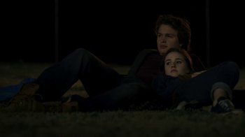 Movie still from “Men, Women & Children” (2014), directed by Jason Reitman – A man and a woman laying on the ground at night; Medium shot, High angle