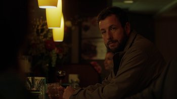 Movie still from “Men, Women & Children” (2014), directed by Jason Reitman – A man sitting at a table with a drink in front of him; Close Up shot, Over the shoulder angle