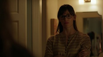 Movie still from “Men, Women & Children” (2014), directed by Jason Reitman – A woman wearing glasses standing in front of a window; Medium shot, Over the shoulder angle