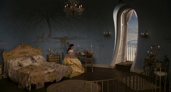 Movie still from “Mirror Mirror” (2012), directed by Tarsem Singh – A woman sitting on a bed in front of a window; Wide shot, High angle