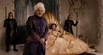Movie still from “Mirror Mirror” (2012), directed by Tarsem Singh – Two people dressed in costumes in a living room; Medium shot, Over the shoulder angle