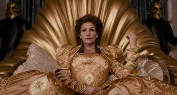 Movie still from “Mirror Mirror” (2012), directed by Tarsem Singh – A woman sitting on top of a gold chair; Medium shot, Overhead angle