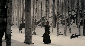 Movie still from “Mirror Mirror” (2012), directed by Tarsem Singh – A man standing in the snow next to trees; Wide shot, Low angle