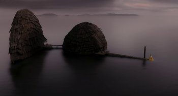 Movie still from “Mirror Mirror” (2012), directed by Tarsem Singh – A large rock sitting in the middle of a body of water; Extreme Wide shot, High angle