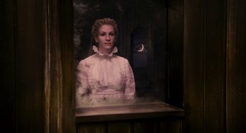 Movie still from “Mirror Mirror” (2012), directed by Tarsem Singh – A woman in a white dress standing next to a window; Medium shot, Low angle