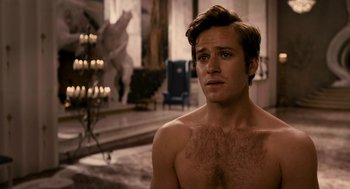 Movie still from “Mirror Mirror” (2012), directed by Tarsem Singh – A shirtless man in a room with candles and a chair; Close Up shot, Over the shoulder angle