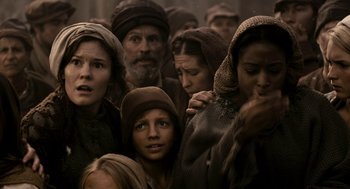 Movie still from “Mirror Mirror” (2012), directed by Tarsem Singh – A group of people standing around each other in a room; Medium shot, Low angle