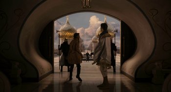 Movie still from “Mirror Mirror” (2012), directed by Tarsem Singh – Two people are standing in an archway of a building; Wide shot, Low angle