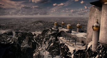 Movie still from “Mirror Mirror” (2012), directed by Tarsem Singh – An aerial view of a mountain with a bunch of buildings; Extreme Wide shot, High angle