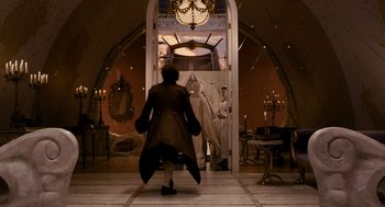 Movie still from “Mirror Mirror” (2012), directed by Tarsem Singh – A man in a white robe and a woman in a white robe and a man in a white robe and a man in a white robe and a; Wide shot, Low angle