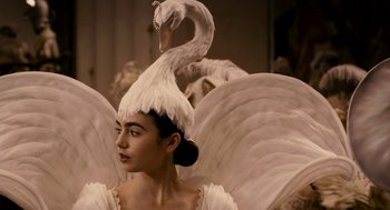 Movie still from “Mirror Mirror” (2012), directed by Tarsem Singh – A woman in a swan costume with a swan on top of her head; Close Up shot, Over the shoulder angle