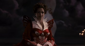 Movie still from “Mirror Mirror” (2012), directed by Tarsem Singh – A woman dressed in a red and white costume; Medium shot, Low angle