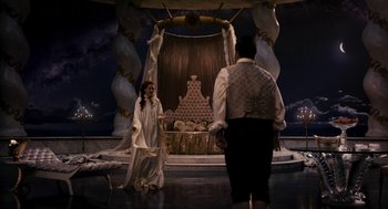 Movie still from “Mirror Mirror” (2012), directed by Tarsem Singh – A man and a woman standing in front of a throne; Wide shot, High angle