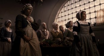 Movie still from “Mirror Mirror” (2012), directed by Tarsem Singh – A group of people dressed in period clothing; Medium shot, Low angle