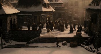 Movie still from “Mirror Mirror” (2012), directed by Tarsem Singh – A group of people walking down a snowy sidewalk; Extreme Wide shot, High angle