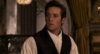 Movie still from “Mirror Mirror” (2012), directed by Tarsem Singh – A person wearing a suit and tie; Close Up shot, Over the shoulder angle