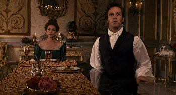 Movie still from “Mirror Mirror” (2012), directed by Tarsem Singh – A man and a woman sitting at a dinner table; Medium shot, Over the shoulder angle